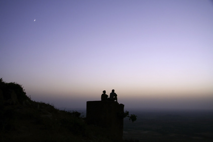 couple chilling out on top of hill